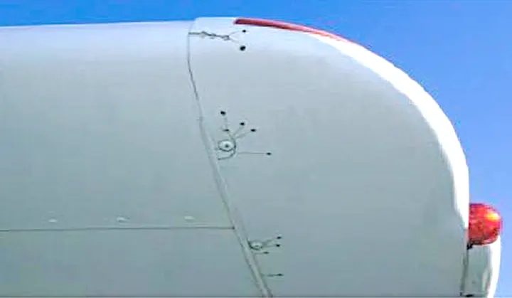 Cracks radiating from screw holes that have been stop-drilled to prevent crack progression