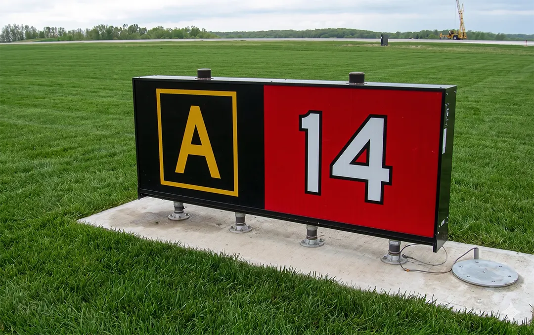 Runway holding position sign at takeoff end of Runway 14 with collocated Taxiway Alpha location sign